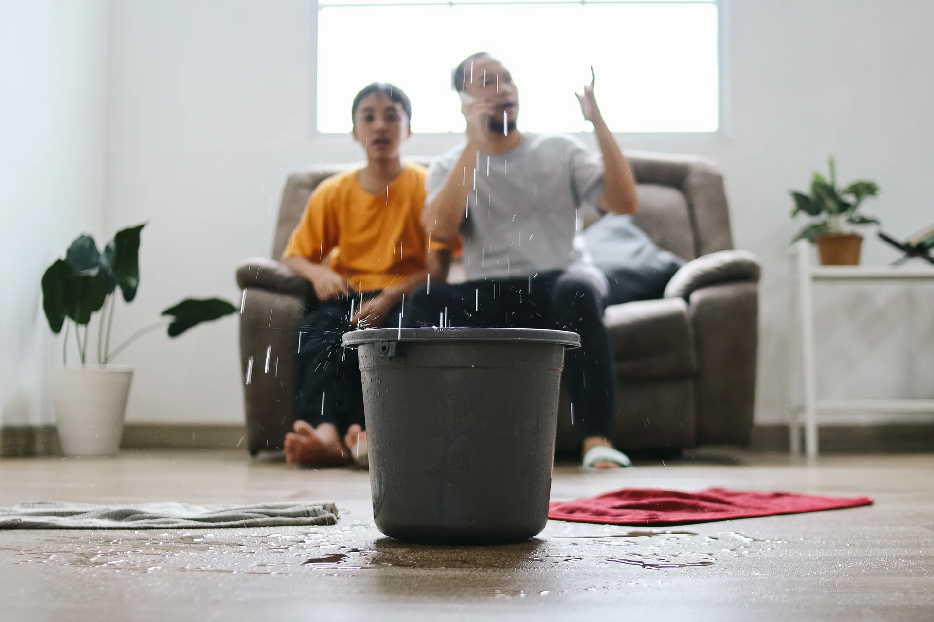 home owner call leak detection company while water is leaking from roof 